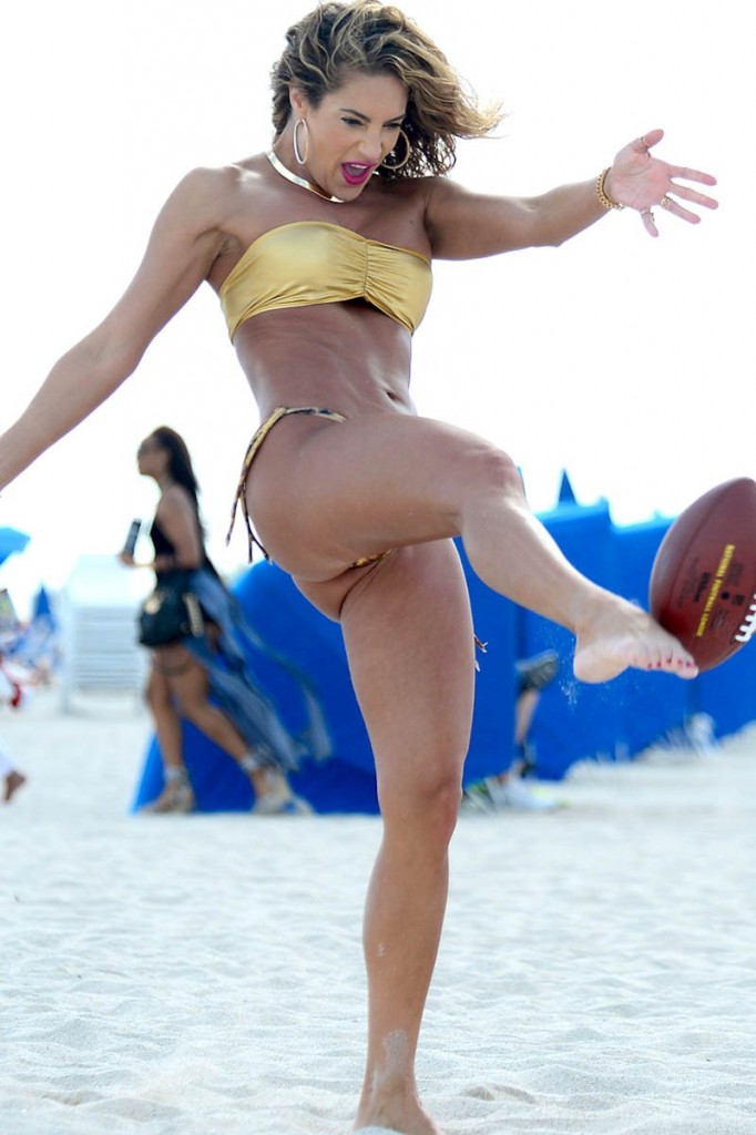 Jennifer Nicole Lee enjoys day at the beach playing football in Miami